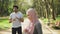 Pretty woman in hijab holding water of bottle while muslim guy standing behind and looking aside. Young family in