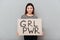 Pretty woman holding blank with text about girls power.