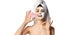 Pretty woman just after shower with facial mask holds pink face exfoliator brush silicone cleansing device for skin shows ok sign