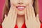 Pretty woman lips and hand with manicured nails. Pink nail polish and makeup lips with natural pink color lipgloss