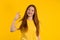 Pretty woman makes hand sign okay, ok gesture. Happy ginger girl, correct perfect choice, great deal, yellow background