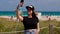 Pretty woman at Miami Beach takes a selfie at the beach