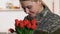 Pretty woman military uniform sniffing tulips bouquet, veterans day, patriotism