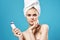 pretty woman naked shoulders towel on head massage blue background