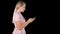 Pretty woman in pink dress texting on smart phone, Alpha Channel