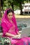 Pretty woman in Pink Indian clothes with laptop .