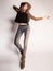 Pretty woman posing in denim pants and boots and black hat - intentional motion blur