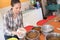 Pretty woman preparing bowls dog food at animal shelter