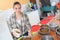 Pretty woman preparing bowls dog food at animal shelter