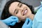 Pretty woman`s teeth cleaning in dental clinic