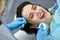 Pretty woman`s teeth treatment in dental clinic