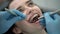 Pretty woman`s teeth treatment in dental clinic