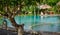 A Pretty woman sitting in the tropical shade a pool 4