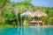 A Pretty woman sitting in the tropical shade a pool