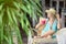 Pretty woman with straw hat sitting in the tropical shade