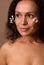 Pretty woman with vitiligo and dermatological skin problems posing with Gypsophila white sprigs on her face. Cosmetology,