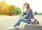 Pretty woman wearing a sunglasses, straw hat and backpack