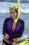 Pretty woman in wetsuit going snorkeling