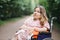 Pretty woman who using wheelchair relaxing alone at park