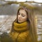 Pretty woman in a yellow knit scarf. Outdoor portrait.