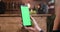 Pretty womans holding a smartphone in her right hand with chroma key