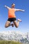 Pretty women joyfully jumping in the mountains