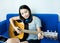 Pretty women play acoustic guitar