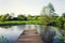 Pretty wooden pier at pond during sunset, colorful summer day, new life change concept, fresh start, new year resolution