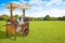 Pretty wooden portable traditional italian picturesque ice cream cart with umbrella in a public park