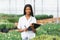 Pretty young african gardener portrait in greenhouse