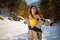 Pretty young asian woman in ski clothing having winter rest outdoor.