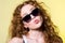 Pretty young beautiful girl in sunglasses makes lips kiss