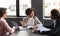 Pretty young black businesswoman giving her team instructions, office interior