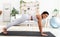 Pretty young black lady doing domestic training on yoga mat, standing in plank, strengthening abs muscles at home