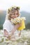 Pretty young blonde woman with camomiles in white blooming field. girl in camomile wreath