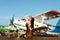 Pretty young businees woman in leather skirts and glasses near the ancient airplane. Fashion Lifestyle, Traveling and technology.