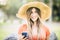 Pretty young caucasian woman portrait with trendy hat and phone - long hair cheerful girl in outdoor leisure activity text on the