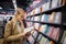 Pretty, young female choosing a good book to buy