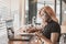 A pretty young focused professional asian woman writing down notes or making a draft. Office worker, businesswoman or freelancer