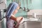 Pretty young girl concentrating on drying dishes at the kitchen sink