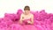 Pretty young girl in gorgeous pink dress, sitting