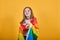 Pretty young girl keeping fist up, covering LGBT flag