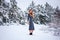 Pretty young girl posing in the winter in cold forest