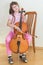 Pretty young girl practice playing cello