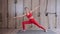 Pretty young girl practice yoga indoors. Stretching, fitness in wellness class.