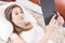 Pretty young girl reading a book in bed