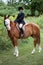 Pretty young girl showing her horse