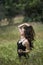 Pretty young lady among large weeds field