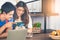 Pretty young lady looking at smartphone with her boyfriend. Asian couple doing online shopping together on weekend. Young