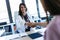 Pretty young obstetrician gynecologist and pregnant woman shaking hands in the first visit in the clinic